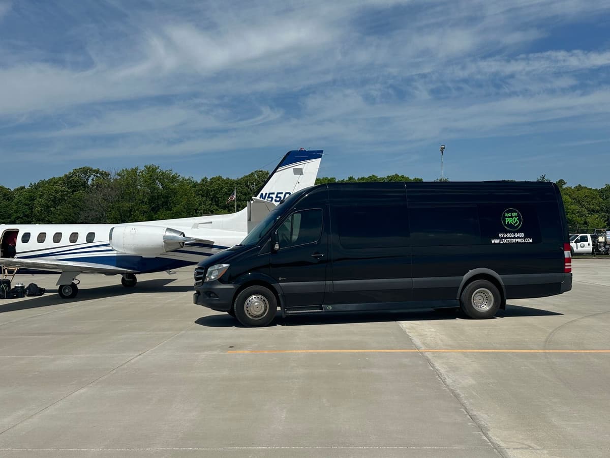 Lake Ride Pros Executive Sprinter beside a private aircraft